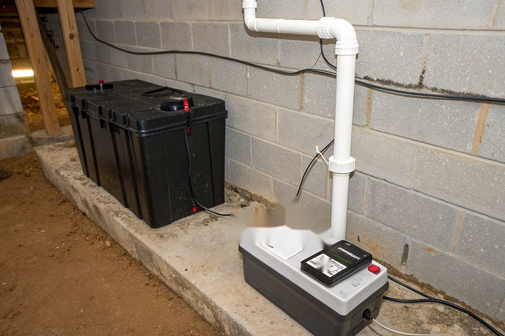 A battery backup unit mounted beside a sump pit with its controller